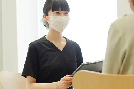 診査・診断・治療説明をしている女性歯科医師