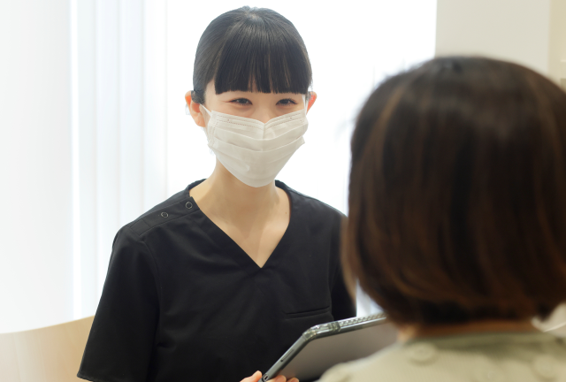 患者と会話している女性歯科医師